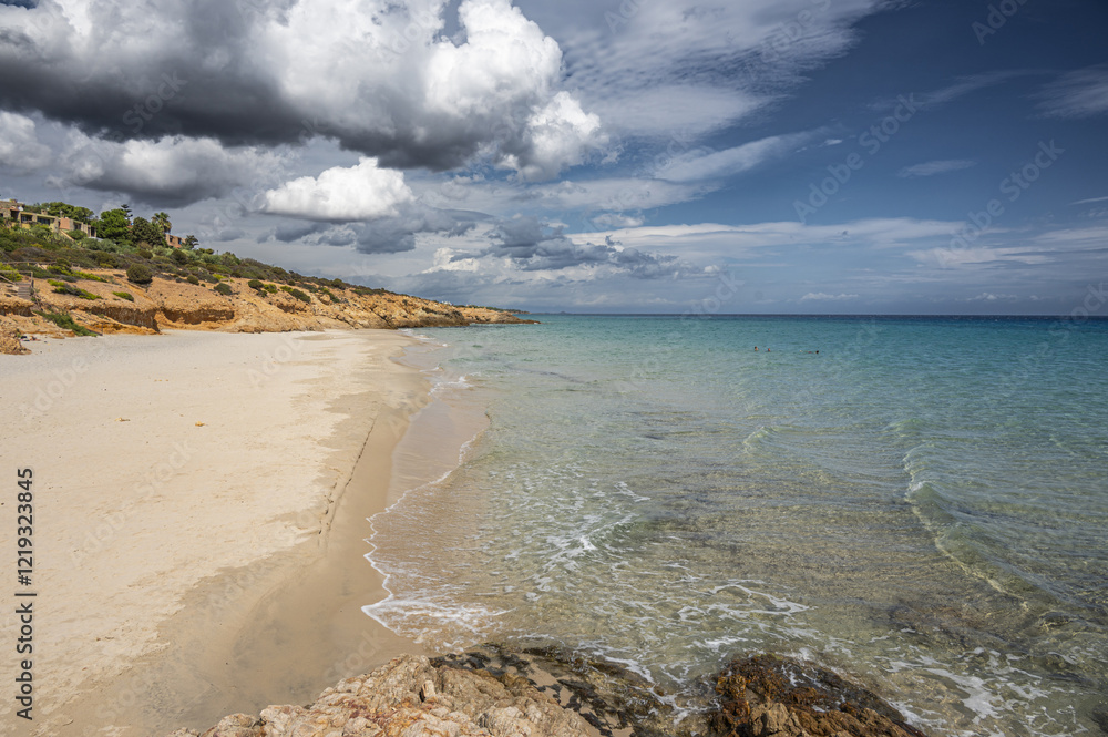 The beautiful beach of Pinus with fine sand and blue and turquoise water and storm clouds on the horizon
