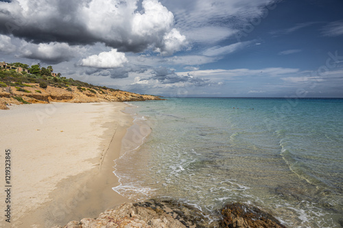 The beautiful beach of Pinus with fine sand and blue and turquoise water and storm clouds on the horizon
