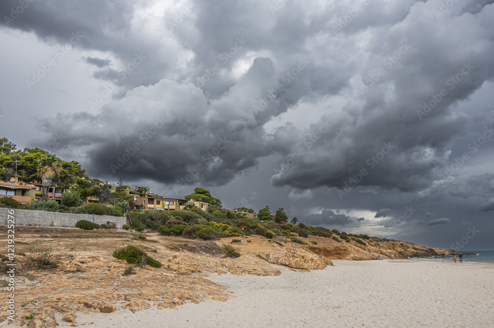 The beautiful beach of Pinus with fine sand and blue and turquoise water and storm clouds on the horizon