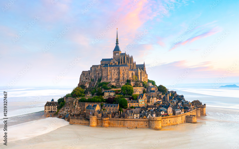 Mont Saint-Michel island with abbey and small town in the sunset light. Normandy, northern France