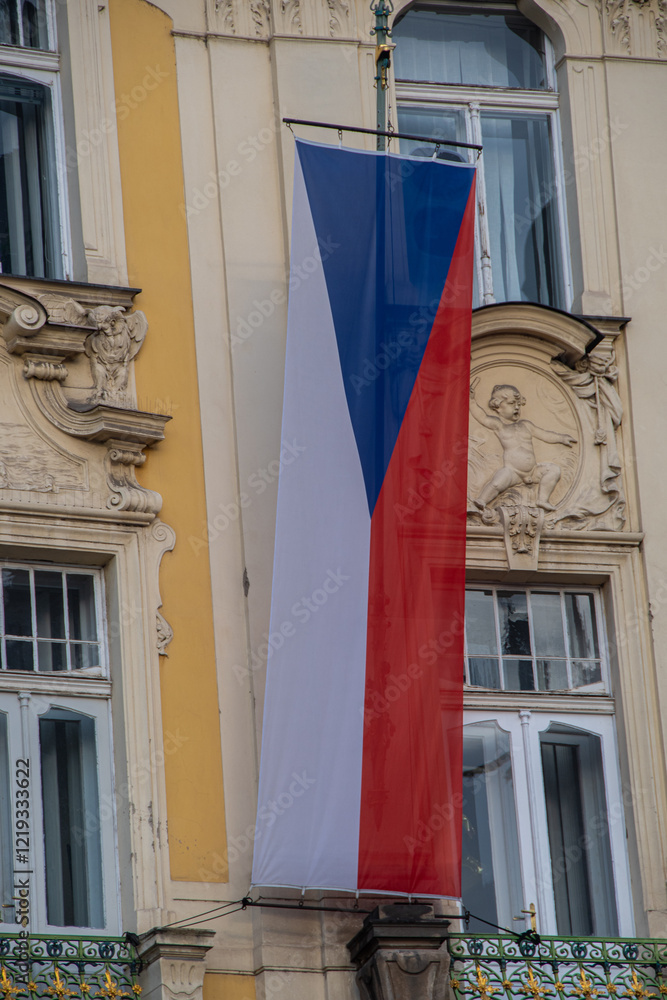 The Czech national flag hangs on a balcony