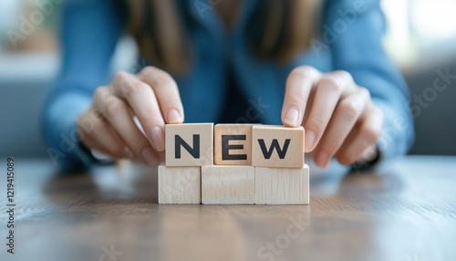 Woman Arranging Wooden Cubes With The Phrase New Normal To Adapt To Life Post-Lockdown After The Covid-19 Pandemic, Focusing On Social Distancing And Hygiene Measures.