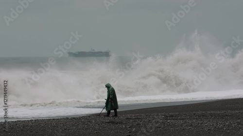 Man gold prospector with metal detector looking for luck on the seashore 