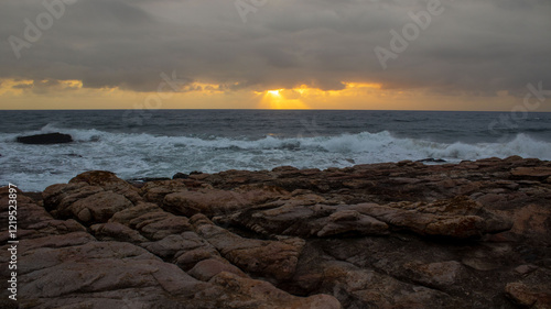 Sunrise over the ocean, located at Orange Rocks in Uvongo in Margate, South Africa photo