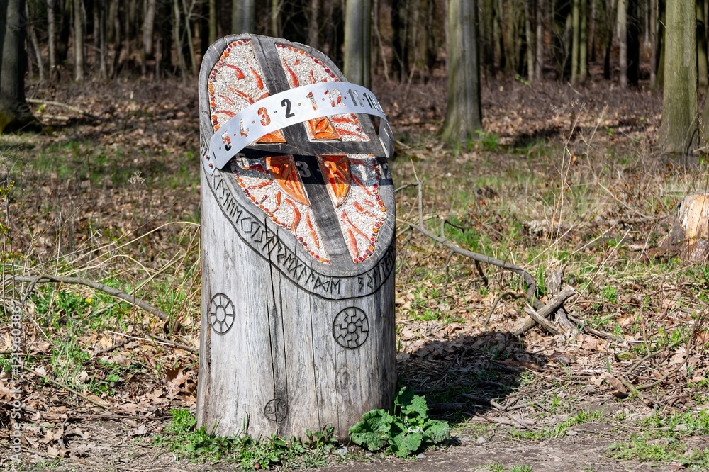 Wooden and metal sundial in Porubsky lesopark forest in Ostrava