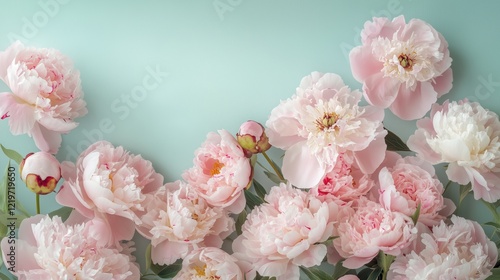 A blank greeting card mockup surrounded by a delicate frame of pink peonies on a soft pastel green background, offering ample copy space for holiday greetings like Valentine's Day or Mother's Day.