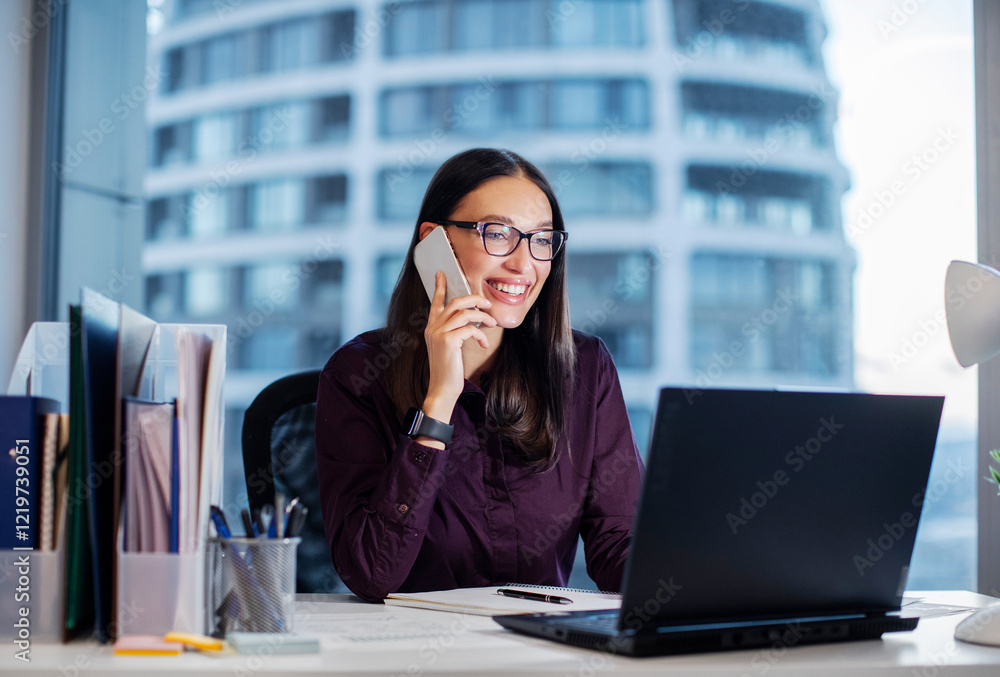 © Home-stock - Happy business lady, broker or manager, sitting at workplace in modern office, working with laptop and talking to client or employees on smartphone © Home-stock - Happy business lady, broker or manager, sitting at workplace in modern office, working with laptop and talking to client or employees on smartphone