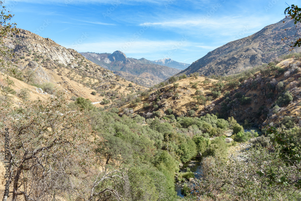 Wooded slopes in Californian Sierra Nevada under blue sky on a sunny autumn day Wooded slopes in Californian Sierra Nevada under blue sky on a sunny autumn day