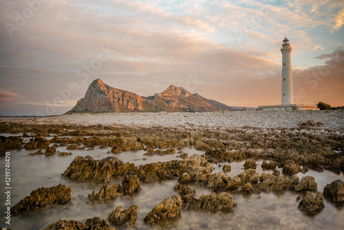 Lighthouse in San Vito Lo Capo at sunset, northwestern Sicily, Italy