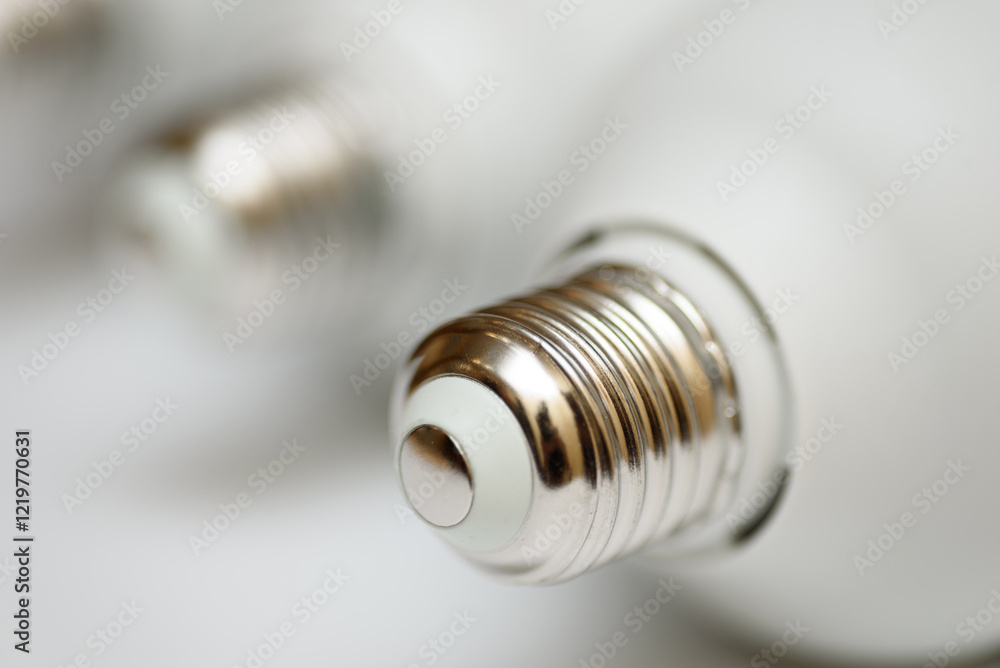 white eco-friendly energy-saving light bulb, metal base close-up, isolated on white background white eco-friendly energy-saving light bulb, metal base close-up, isolated on white background