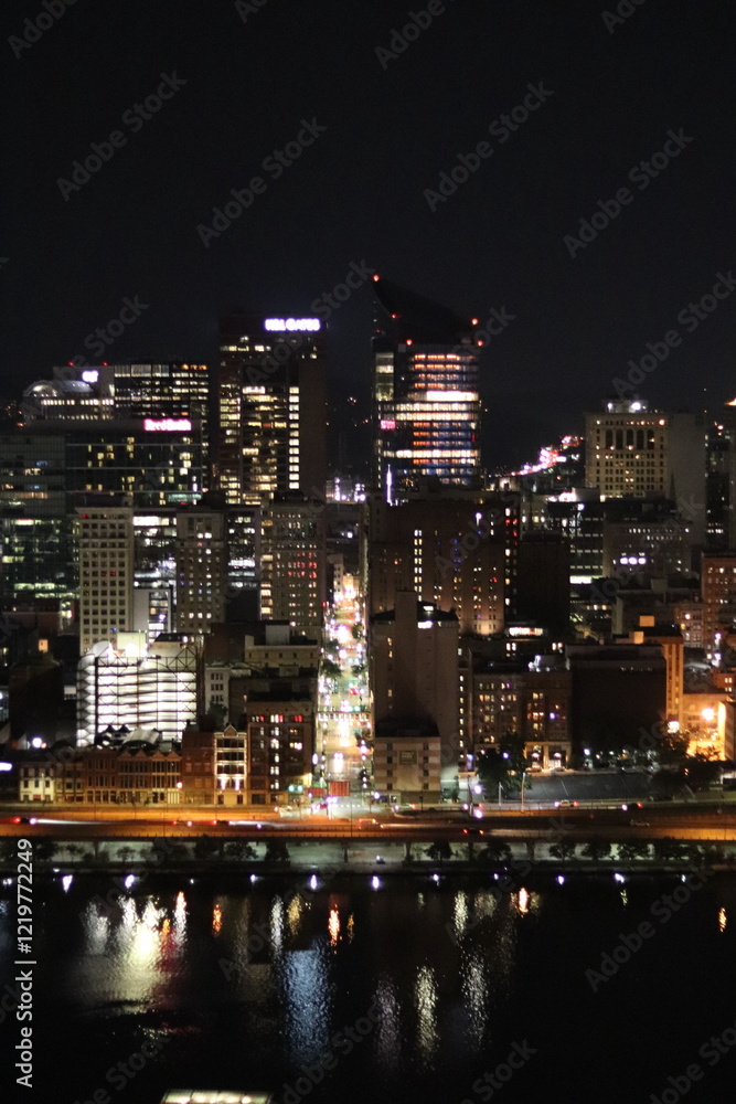 Naklejka premium Birds eye view of the city skyline of downtown Pittsburgh, Pennsylvania at night.