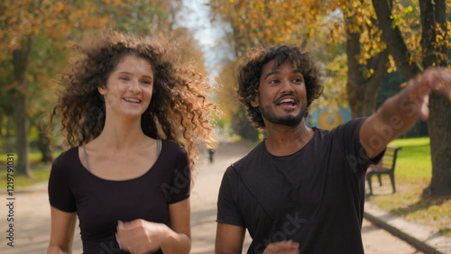Εκτύπωση καμβά Arabian Indian Caucasian multiracial couple running together in city outdoors ha