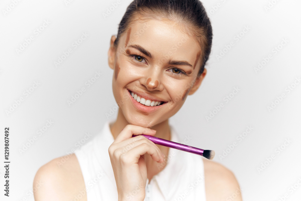 Smiling beauty model with makeup brush showcasing natural makeup style and confidence, perfect for cosmetic and beauty promotions. Smiling beauty model with makeup brush showcasing natural makeup style and confidence, perfect for cosmetic and beauty promotions.