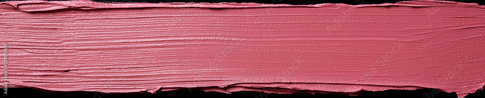 Fototapeta premium Soft pink paint swatch spread smoothly on a black background showcasing texture and color depth