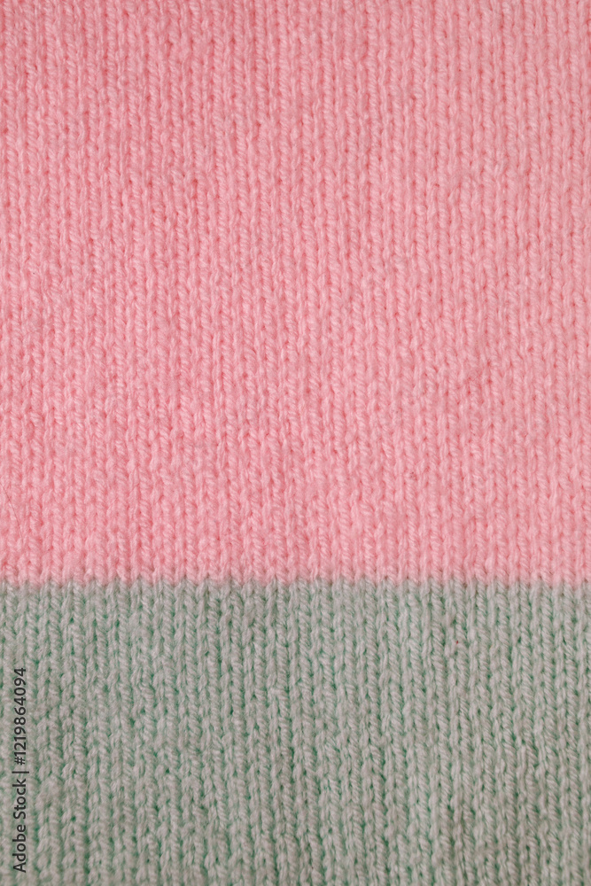 Fototapeta premium knitted fabric from wool and acrylic yarn in simple stocking stitch in pink and turquoise colors. Knitting as a way to relax and earn extra money.