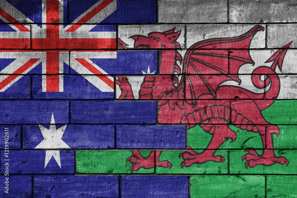 Obraz premium colourful painted big flag of australia and flag of wales on a massive old brick wall background. concept