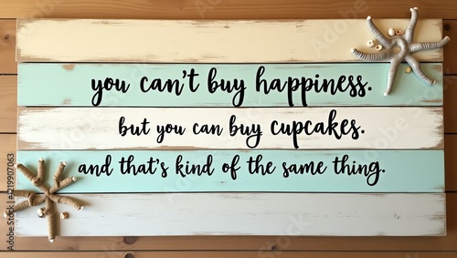 you can�t buy happiness, but you can buy cupcakes, and that�s kind of the same thing is displayed in black minimalist lettering across separate distressed wood planks in beach-inspired tones