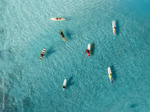 Drone Aerial View of Surfers Riding Waves in Hawaii Sea with Surfboards in the Blue transparent Ocean 