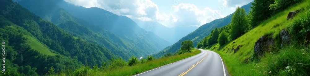 Fototapeta premium Narrow winding road through lush green mountains, trees, clouds, landscape
