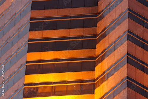 Abstract futuristic architectural background. Office building windows in black and orange tones.
