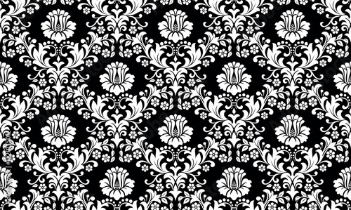 Wallpaper in the style of Baroque. Seamless vector background. White and black floral ornament. Graphic pattern for fabric, wallpaper, packaging. Ornate Damask flower ornament.