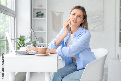 Young woman with laptop and...