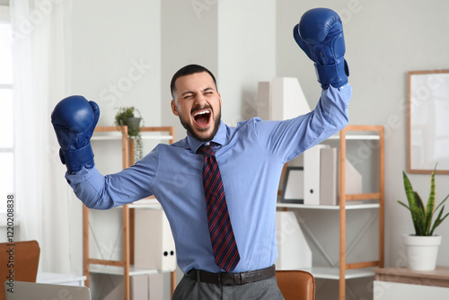 Angry businessman with boxi...
