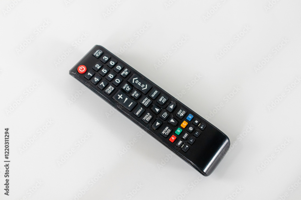 A tv remote with many buttons on white background A tv remote with many buttons on white background