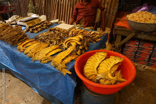 Mixed dried fish are displayed and sold at a fish market, Different types of dried fish along with hilsa are sold by a street vendor, All types of dried salted fish in the Asian biggest seafood market photo