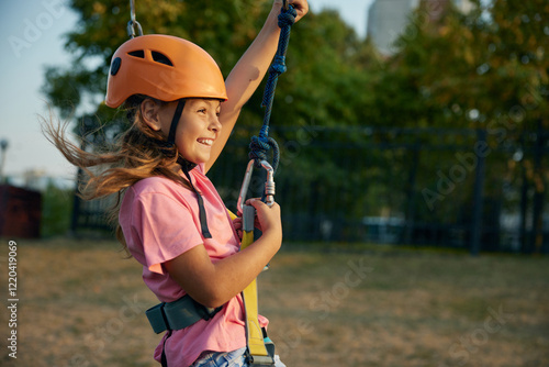 Quadro su tela Child girl going down zipline inclined rope with a suspended harness