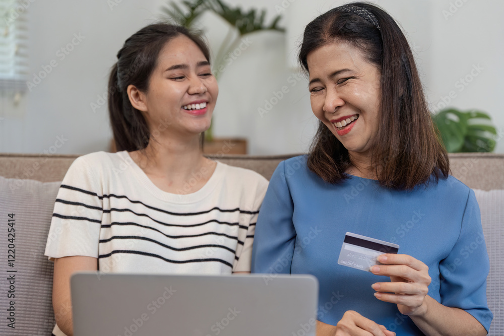Mother and Child Enjoying Online Shopping Together with Credit Card on Laptop at Home Mother and Child Enjoying Online Shopping Together with Credit Card on Laptop at Home