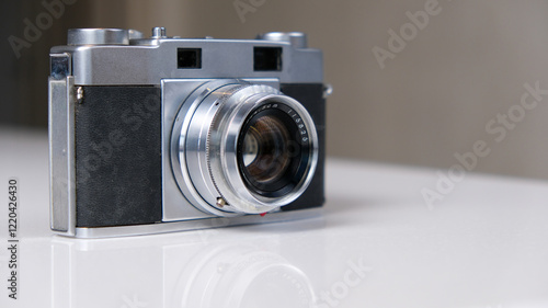 A vintage film camera is waiting for you on the table. When will you start taking pictures
