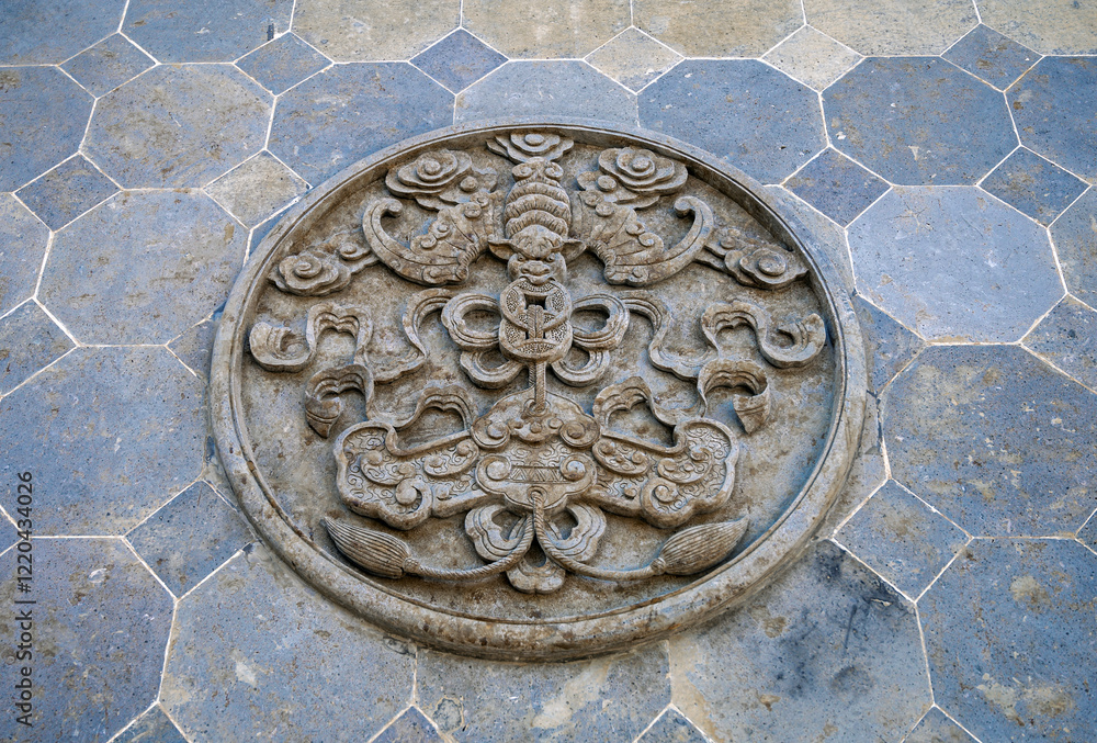 Exquisite round stone carved floor tiles on the street floor of ancient town in China Exquisite round stone carved floor tiles on the street floor of ancient town in China