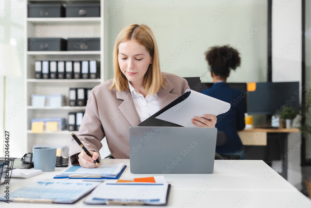 Businesswomen hand working with tablet and laptop computer with documents on office desk. Businesswomen hand working with tablet and laptop computer with documents on office desk.