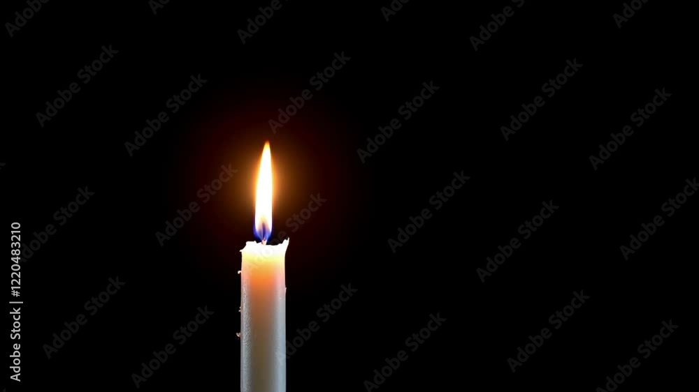Burning candle with a calm, flickering flame creating a peaceful and warm atmosphere in the dark. Burning candle with a calm, flickering flame creating a peaceful and warm atmosphere in the dark.