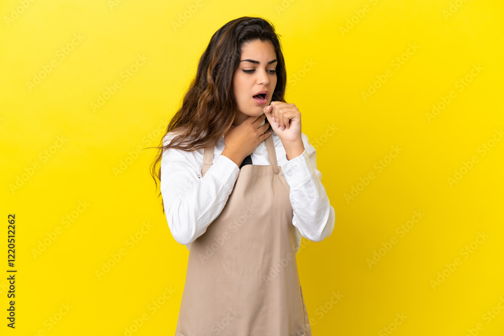 Young caucasian restaurant waiter isolated on yellow background is suffering with cough and feeling bad Young caucasian restaurant waiter isolated on yellow background is suffering with cough and feeling bad