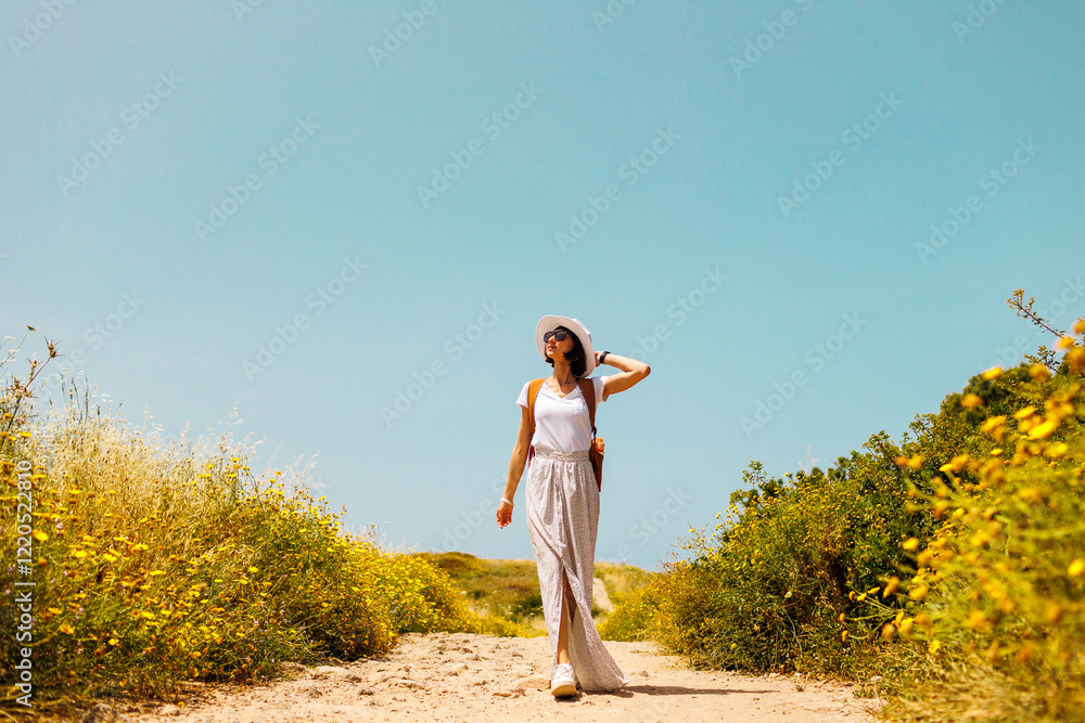 girl in a dress and with a backpack. portrait of a young woman in a light hat and dress against the backdrop of beautiful hills and a beautiful landscape. girl in a dress and with a backpack. portrait of a young woman in a light hat and dress against the backdrop of beautiful hills and a beautiful landscape.