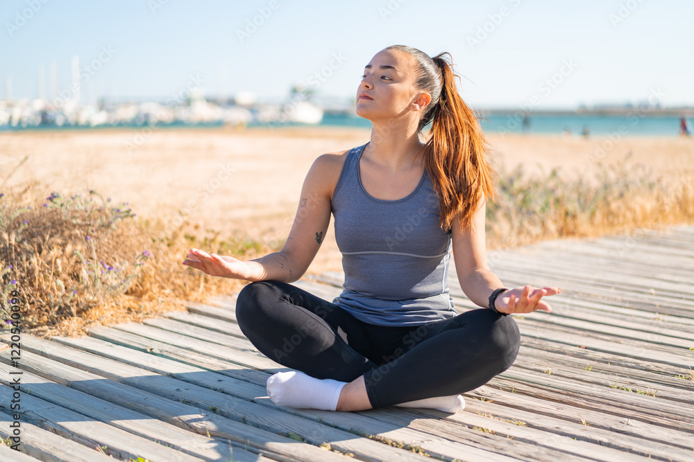 Fototapeta premium Young pretty sport woman doing yoga