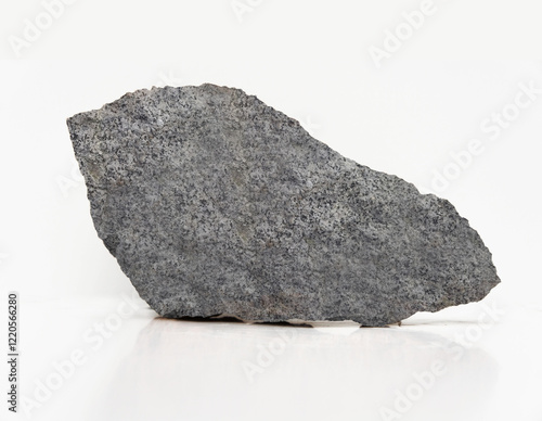 A gray, jagged rock fragment with a rough, speckled surface and sharp edges, showcasing a natural, unpolished texture typical of dense, coarse mineral formations.
