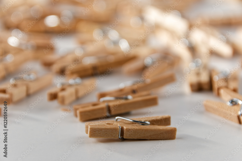 A close-up against a white background of a group of old-fashioned, unsorted wooden clips. A close-up against a white background of a group of old-fashioned, unsorted wooden clips.