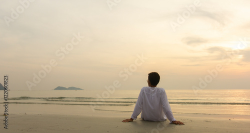 alone man sitting on the beach and looking sky at sunset, relax concept