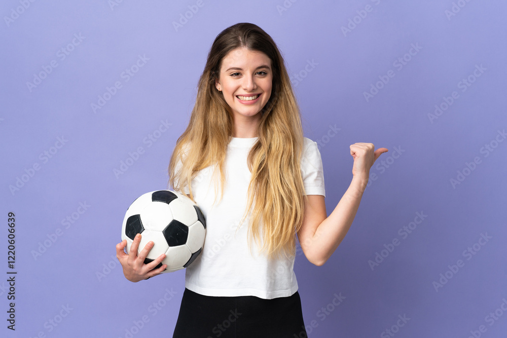 Young blonde football player woman isolated on purple background pointing to the side to present a product Young blonde football player woman isolated on purple background pointing to the side to present a product