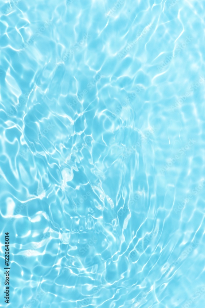 Obraz premium Bluewater waves on the surface ripples blurred. Defocus blurred transparent blue colored clear calm water surface texture with splash and bubbles. Water waves with shining pattern texture background.
