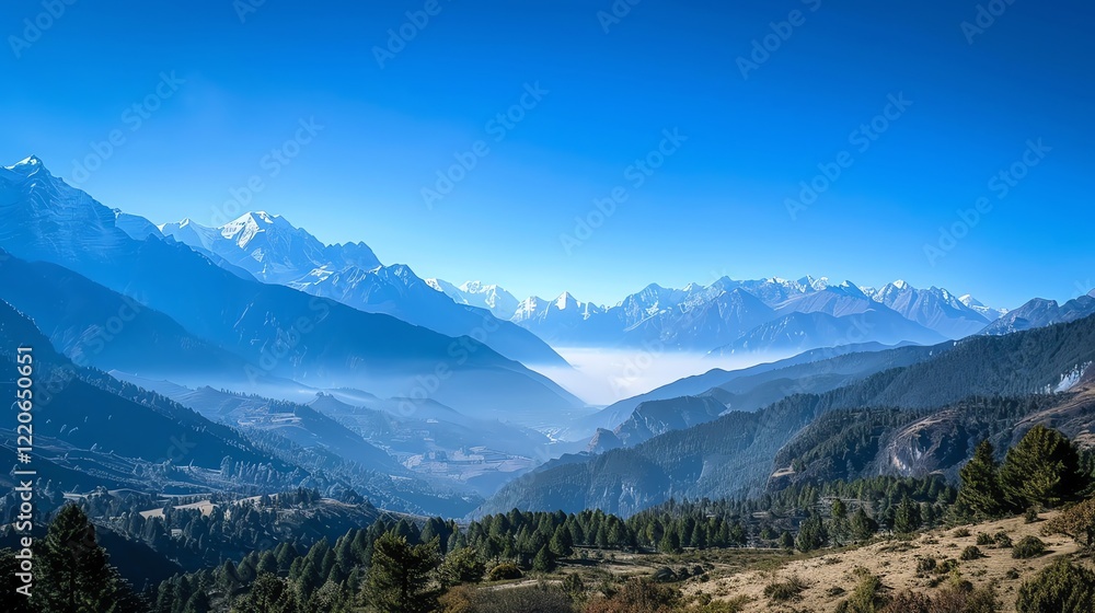 A beautiful view of a mountain range, covered in snow, with a clear blue sky and wispy clouds. A beautiful view of a mountain range, covered in snow, with a clear blue sky and wispy clouds.