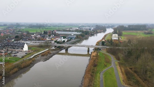 schoonaarde bridge over river scheldt belgium cyclist driving active transportation options forward aerial drone shot view scenic overview  photo