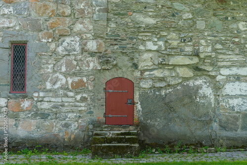 old brick wall on church with a red door - Simplistic