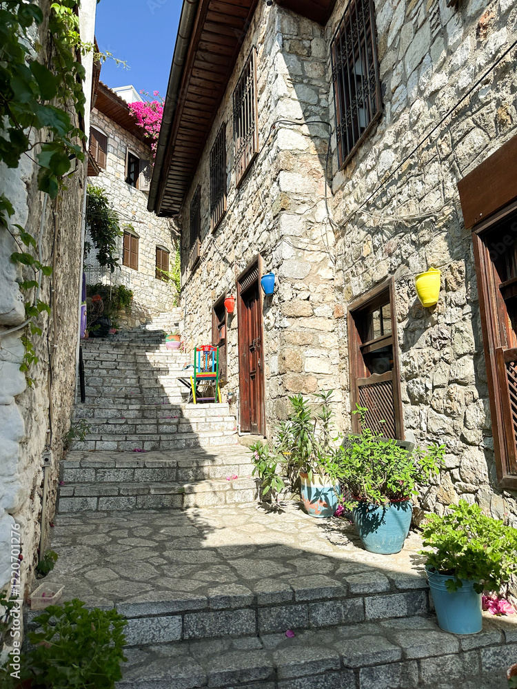 Fototapeta premium Narrow cobblestone street in a traditional village with stone houses.