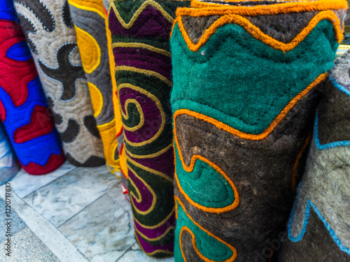 stack of standing rolls of shyrdak - national Kyrgyz felt rugs photo