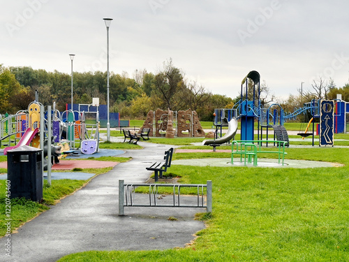 Empty playground derelict swings and slide in rural area