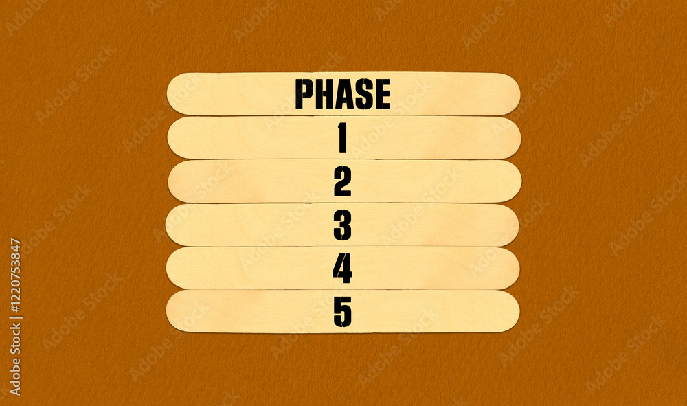 Fototapeta premium Time to Phase Symbol. Concept word Phase 1 2 3 4 5 on beautiful wooden stick. Beautiful Orange Chart Paper Background. Business and Time to Phase concept. Copy space